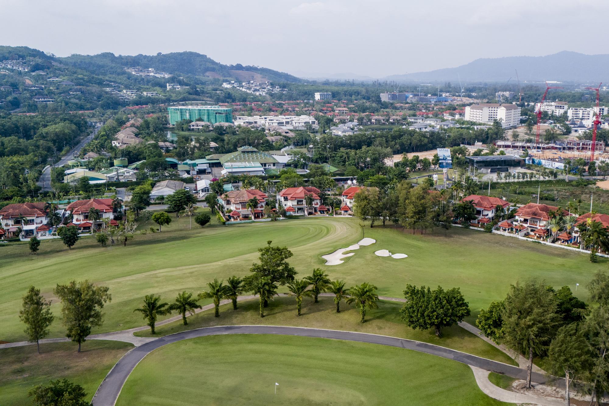 Panoramic aerial view over the Laguna Phuket golf course towards the hills