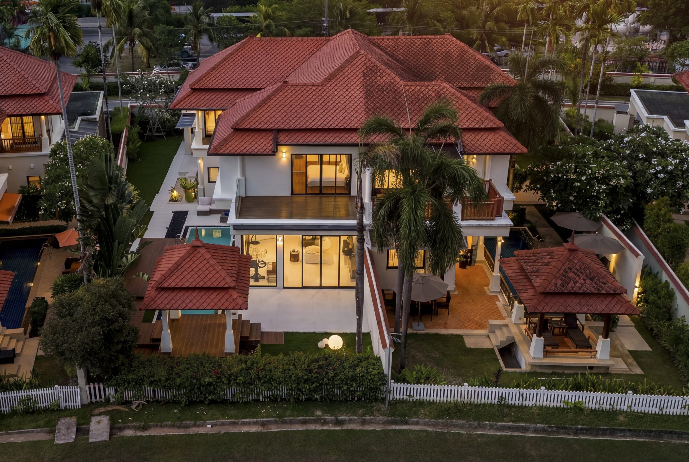 Laguna Fairway villa at dusk, pool and gardens lit, golf course beyond